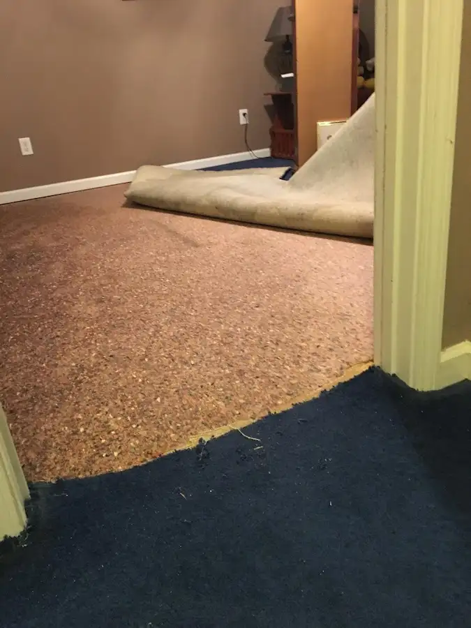 Carpet pad removal revealing water damage during Drying & Dehumidification in Mustang